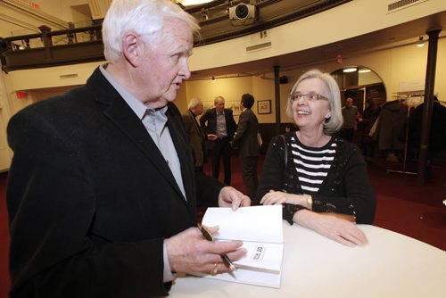 February 17, 2015 - 150217  -  University of Winnipeg history professor Robert Young signs a book for former student Lynne Schultz at the launch of his book Premonitions of War: The Winnipeg Free Press And The Hitler Years  Tuesday, February 17, 2015. John Woods / Winnipeg Free Press