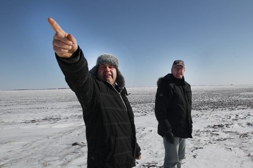 Domain, Manitoba- Manitoba farmers Rick Nychuk, left, and Jurgen Kohler are in a group that is opposing the way expropriation of land for Bipole III is being handled.- They stand in area south of Domain, Manitoba where line will cross-See Bill Redekop story - Feb 18, 2015   (JOE BRYKSA / WINNIPEG FREE PRESS)