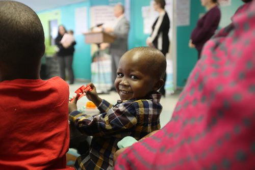 Two-year-old Ali Abdu Omer who recently immigrated from Chad to Canada with his family shares a warm smile as he plays with toys at the press conference for the launch of the early childhood development strategy at Immigrant and Refugee Community Organizations of Manitoba on Wednesday.  Feb 18, 2015 Ruth Bonneville / Winnipeg Free Press