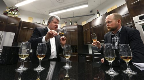 Ent./Uptown. At left Gary Dawyduk, Liquor Marts product ambassador and Ben do a visual analysis of one of the whisky samples at the Grant Park Liquor Mart in their education centre.  Ben MacPhee-Sigurdson  story Wayne Glowacki/Winnipeg Free Press Feb.18   2015