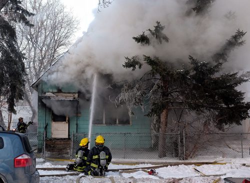 WFPS work on putting out a house fire at 617 and 615 Elgin Ave Wednesday afternoon.  150218 February 18, 2015 Mike Deal / Winnipeg Free Press