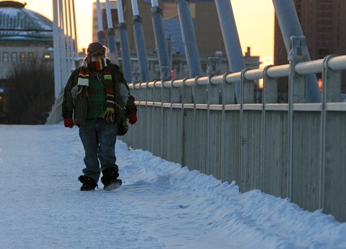 Ryan Spies braves -23C and -30C windchill Wednesday afternoon as he crosses the Esplanade Riel on his walk home from work.  150218 - Wednesday, February 18, 2015 - (Melissa Tait / Winnipeg Free Press)