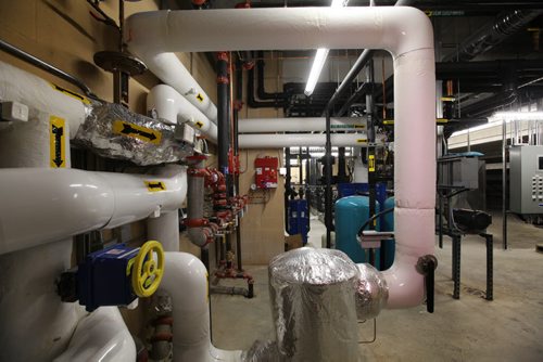 Dozens of hoses and pipes interconnect to the furnaces in the mechanical room in the Peguis Arena which was built in spring of 2014 and is powered by geothermal energy.    Feature story on how sustainable energy sources like  geothermal and solar are being implemented on First Nation reserves like Peguis and Fisher River and its positive impact on the people and our province.   See Alex Paul story.   Feb 17, 2015 Ruth Bonneville / Winnipeg Free Press