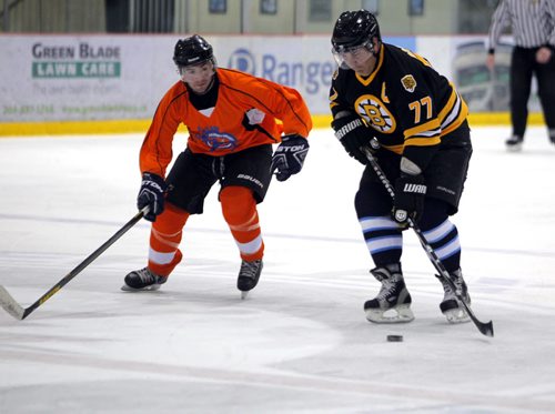 SPORTS/LOCAL/BIZ - The Mike Keane Celebrity Hockey Classic, held this year on February 18 and 19, 2015 at MTS Iceplex. Right, former NHL star Ray Bourque battles with    MacDon's team member during the event. BORIS MINKEVICH/WINNIPEG FREE PRESS FEB. 19, 2015