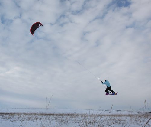 Carlos Abodu takes full advantage of our windy city  by harnessing its power to propel him across the snow and into the air in the fields along Kenaston Blvd Thursday. Standup photo Feb 19, 2015 Ruth Bonneville / Winnipeg Free Press