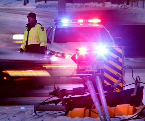 Motorists should take caution on the streets Friday morning after a light overnight snow fall. Winnipeg Police were out directing traffic on Henderson Hwy. at Chief Peguis Trail after a traffic light was taken down.   Wayne Glowacki/Winnipeg Free Press Feb.20   2015