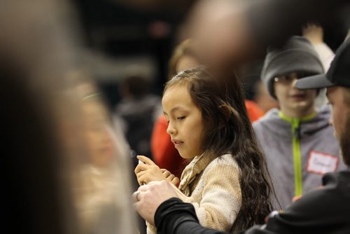 Eight year-old Shaunna Chief-Parker, who is visually impaired, explores vehicles using her sense of touch during a special touch tour for kids with vision loss Friday sponsored by Monster Truck Jam. Standup photo Feb 20, 2015 Ruth Bonneville / Winnipeg Free Press