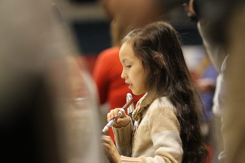 Eight year-old Shaunna Chief-Parker, who is visually impaired, explores vehicles using her sense of touch during a special touch tour for kids with vision loss Friday sponsored by Monster Truck Jam. Standup photo Feb 20, 2015 Ruth Bonneville / Winnipeg Free Press