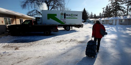 Heading to the Crystal City's Parklane Theatre Thursday evening technician Ian Kirk moves from his hotel room to an idling rental truck in Carman after the previous nights performance there.  See Kevin Prokosh story. February 19, 2015 - (Phil Hossack / Winnipeg Free Press)