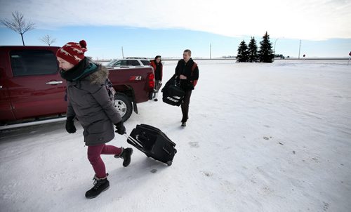 Arriving at their Pilot Mound accomodations, MTC's travelling troupe ( Aprentice Airyn Lancaster left, Stage Manager Kathryn Ball center, and actor Justin Oho) unloads before moving to neighboring Crystal City for their evening performance.  See Kevin Prokosh story. February 19, 2015 - (Phil Hossack / Winnipeg Free Press)