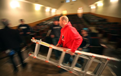 Crystal City Community volunteers manhandle pieces of MTC's set and gear  around  the ParkLane Theatrefor the evening performance of Armstrong's War.  (Kevin has this guy's name). See Kevin Prokosh story. February 19, 2015 - (Phil Hossack / Winnipeg Free Press)