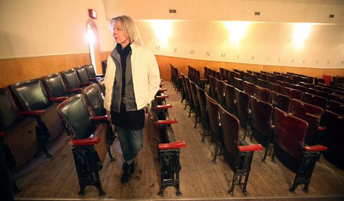 Community Volunteer (Kevin has her name) stands amidst antique theatre seats that date back at least one previous community hall at the ParkLane Theatrefor the evening performance of Armstrong's War in Crystal City Thursday.  (Kevin has this guy's name). See Kevin Prokosh story. February 19, 2015 - (Phil Hossack / Winnipeg Free Press)