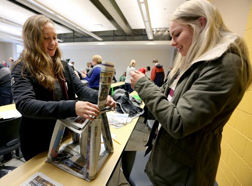 Cassidy Maidment and Bailey Horn, both 17 year old students at Balmoral Hall, participating in a "newspaper chair challenge" as part of Science Engineering and Technology Day at the Engineering Faculty at the University of Manitoba, Friday, February 20, 2015. (TREVOR HAGAN/WINNIPEG FREE PRESS)