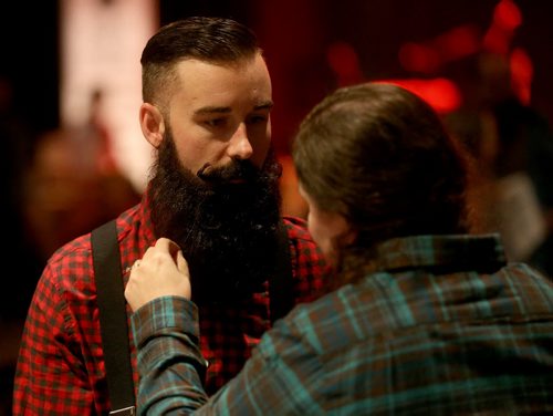 Anthony Domienik, second time competitor has his beard touched up by his wife, Chelsea, prior to the 33rd Beard Growing Contest, Friday, February 20, 2015. (TREVOR HAGAN/WINNIPEG FREE PRESS)