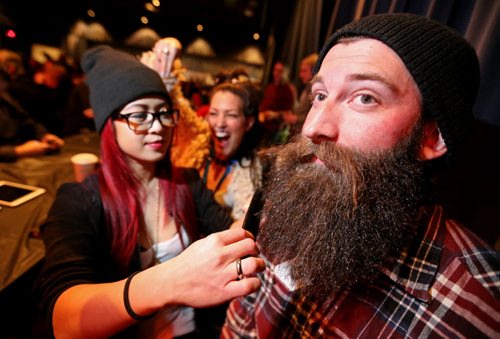 Holly Hui, a haird dresser from Berns and Black touches up Travis Martin's beard prior to the 33rd Beard Growing Contest, Friday, February 20, 2015. (TREVOR HAGAN/WINNIPEG FREE PRESS)