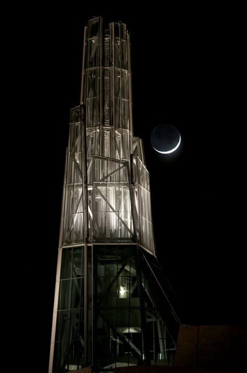 Barely a sliver of the moon is visible as it rises behind the Canadian Museum for Human Rights, Friday, February 20, 2015. (TREVOR HAGAN/WINNIPEG FREE PRESS)