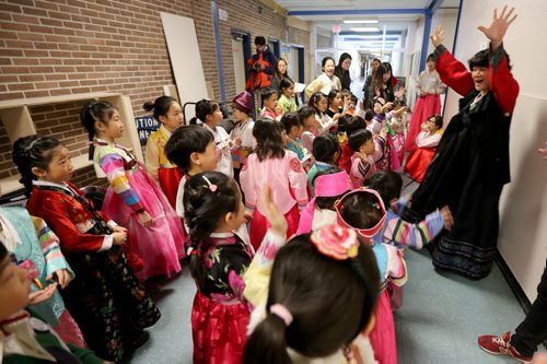 Jungim Park, an instructor at the Korean School at Grant Park, leading a last minute practice with students before a performance before Korean New Year celebrations, Saturday, February 21, 2015. (TREVOR HAGAN/WINNIPEG FREE PRESS)