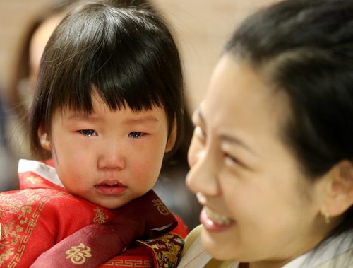 Dayna Lee, 2, a student at the Korean School at Grant Park, crying before a performance for Korean New Year celebrations, Saturday, February 21, 2015. (TREVOR HAGAN/WINNIPEG FREE PRESS)
