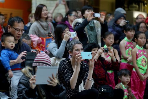 A crowd watches and takes photos as the Great Wall Dance Academy entertains the crowd during Chinese New Year celebrations at The Forks, Saturday, February 21, 2015. (TREVOR HAGAN/WINNIPEG FREE PRESS)