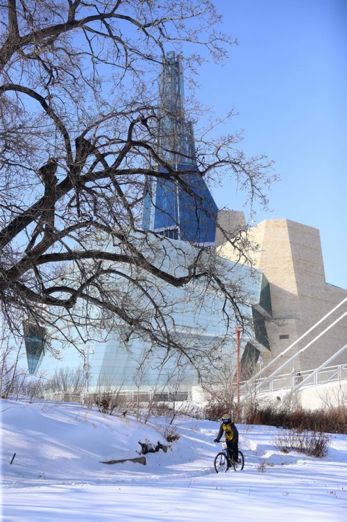With the Canadian Museum for Human Rights in the background, A riders prepares for the 15th annual Ice Bike event, a race on and along the Red River near The Forks, Saturday, February 21, 2015. (TREVOR HAGAN/WINNIPEG FREE PRESS)