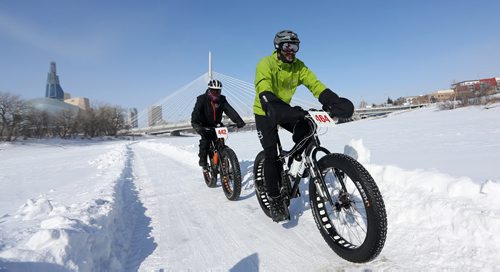 In front of the Canadian Museum for Human Rights and the Esplanade Riel, riders prepare for the 15th annual Ice Bike event, a race on and along the Red River near The Forks, Saturday, February 21, 2015. (TREVOR HAGAN/WINNIPEG FREE PRESS)