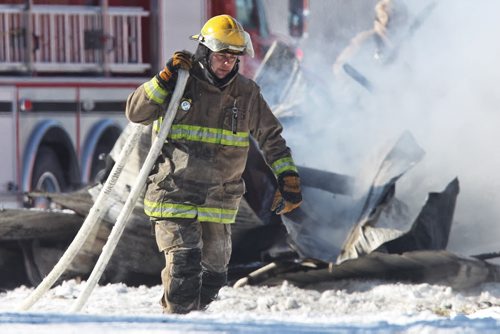 Firefighters continue to put out a barn fire at the Aesgard Ranch, located near Highway 8 in the R.M. of St. Andrews, 60 kilometres north of Winnipeg Sunday afternoon. Horses that were reported to have been housed in the now completely destroyed barn had been rescued and were not harmed by the fire.  150222 February 22, 2015 Mike Deal / Winnipeg Free Press