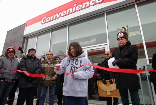 Creelynn Peters, 12, from Long Plain First Nation cuts the ribbon during the grand opening to the brand new Petro Canada gas station on Madison Street, Winnipeg's first urban reserve gas station.  150223 February 23, 2015 Mike Deal / Winnipeg Free Press