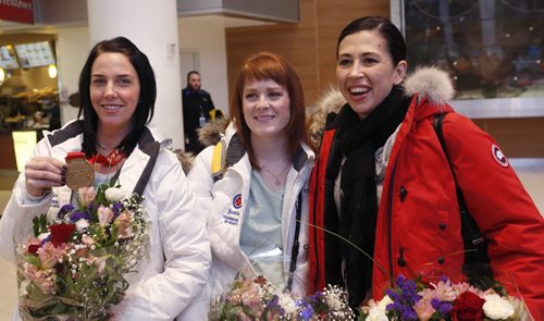 Three members of Team Jones from right, second Jill Officer,  lead Dawn McEwen and  alternate Jennifer Clark-Rouire arrived at James A Richardson International Airport Monday after the team won the Canadian championship in the Scotties Tournament of Hearts Sunday.  Wayne Glowacki/Winnipeg Free Press Feb.23   2015
