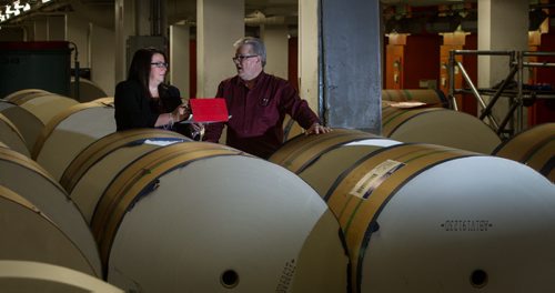 Christine Fehler, VP Operations, with Gord Smith, Pressroom Manager, with rolls of newsprint pose for a portrait for the Winnipeg Free Press Annual Report. 150211 - Wednesday, February 11, 2015 -  (MIKE DEAL / WINNIPEG FREE PRESS)