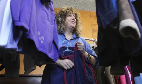 Sid Wittmann checks out the deals available at the Clothesline sale of pre-owned clothes at Broadway-First Baptist Church Thursday afternoon.  The sale runs from 10 - 4pm every third Thursday of the month with all proceeds going to support children's feeding program in Haiti.    Standup photo   Feb 19, 2015 Ruth Bonneville / Winnipeg Free Press