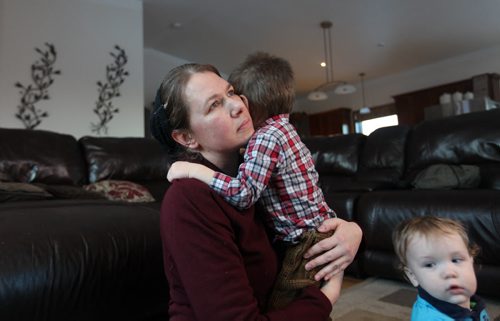 Evelyn Waldner who lives with her husband and 7 children in a nearby home to the Eberhardt family in the RM of Morris, holds her son, Cian (2 and a half) in her lap with her other son Jace (1yrs) next to her; sadly she reflects on the loss of her neighbours children during a house fire that totally demolished the 2-storey home in the RM of Morris Manitoba early Wednesday morning taking the lives of four of the children. See Jen's story.  Feb 25, 2015 Ruth Bonneville / Winnipeg Free Press