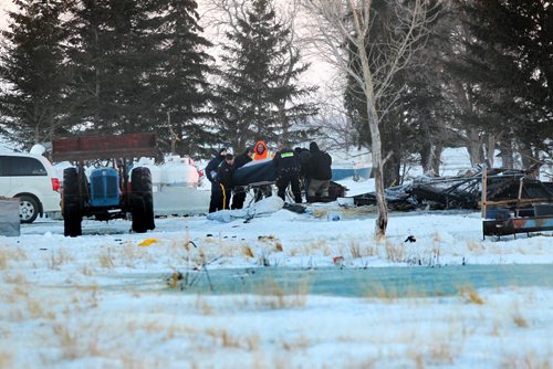 Firefighters and RCMP officers remove a body from a house fire that totally demolished the 2-storey home in the RM of Morris Manitoba early Wednesday morning. See story.  Feb 25, 2015 Ruth Bonneville / Winnipeg Free Press