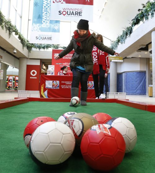 To mark the beginning of the 100 Day Countdown to the FIFA Womens World Cup, Canada 2015,  Liu Mei Yang had the opportunity to play Poolball in the Winnipeg Square Thursday against Margie Reis for a chance to win a pair of tickets and was successful. February 26 also marks the day when the general public has their chance to secure their seat as individual tickets for Canada 2015 are going on sale for $20.15. see release emailed  Wayne Glowacki/Winnipeg Free Press Feb.26   2015