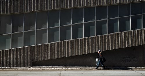 A pedestrian walks by the Radisson Hotel on Smith Street at Portage Avenue as the temperature hovers around -20C Thursday morning.  150226 February 26, 2015 Mike Deal / Winnipeg Free Press