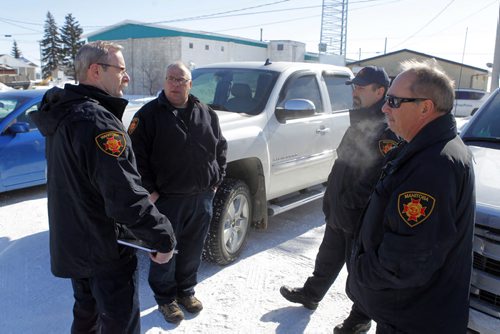 NEWS - KANE FIRE FOLLOW- Investigators from the Office of the Fire Commissioners office debrief in front of the Lowe Farm fire dept.  BORIS MINKEVICH/WINNIPEG FREE PRESS FEB. 26, 2015