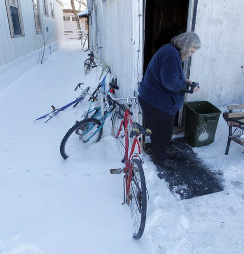 NEWS - KANE FIRE FOLLOW- MORDEN, MB - Beverley Eberhardt, grandmother to the 4 boys that died in the fire. Here she stands outside of her trailer home. On the left is some bicycles that the boys would ride when they were in town.  BORIS MINKEVICH/WINNIPEG FREE PRESS FEB. 26, 2015