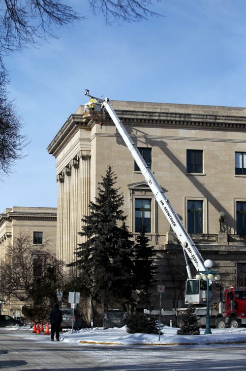 A crew install a camera on the south west corner of the Legislative building Friday afternoon.  Friday, Feb. 26, 2015 Ruth Bonneville / Winnipeg Free Press.