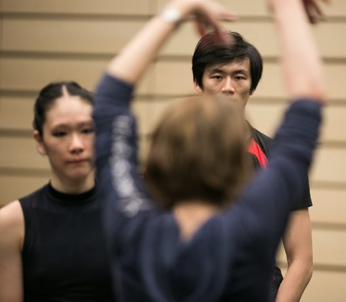 Xing watches ballet master Vanessa Leonard demonstrate while rehearsing the pas de deux in Swan Lake with soloist Sophia Lee.  150220 - Friday, February 20, 2015 - (Melissa Tait / Winnipeg Free Press)