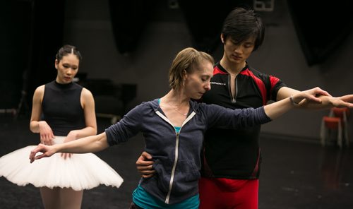 Sophia Lee watches as ballet master Vanessa Leonard demonstrates a position with Xing in rehearsal for the pas de deux in Swan Lake.  150220 - Friday, February 20, 2015 - (Melissa Tait / Winnipeg Free Press)