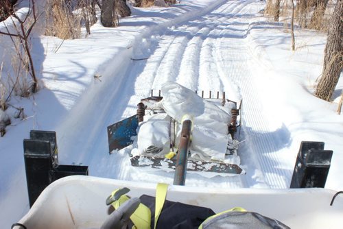 048, 055 - The tracker that cuts the trail for cross-country skiers, is pulled behind a snowmobile, in Riding Mountain National Park. BILL REDEKOP/WINNIPEG FREE PRESS Feb 27, 2015
