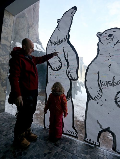 Michael Mullen and his grand daughter, Livinia Bradbury, 3, at the Gateway to the Arctic building at the Assiniboine Park Zoo in front of an art installation by Kal Barteski which is part of special Polar Bear Day celebrations, Saturday, February 28, 2015. (TREVOR HAGAN/WINNIPEG FREE PRESS)