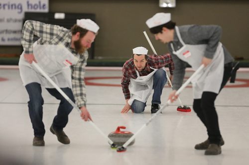 Chris Young, middle, from Ray's Takout throws a rock as Kevin Rempel and Josh Bedry sweep during the Manitoba Music Rocks Charity Bonspiel at the Granite Curling Club, Saturday, February 28, 2015. (TREVOR HAGAN/WINNIPEG FREE PRESS)