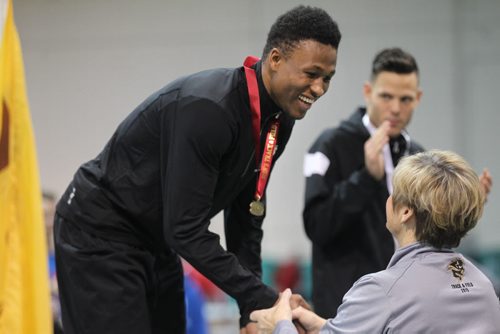 U of M Bison high jump competitor Alhaji Mansaray, gets handed an gold medal for not only winning the mens high jump competition but also  breaking the western Canadian high jump record  of 2.17 metres during the  2015 Canada West Track and Field Championship the Max Bell Fieldhouse Saturday afternoon.   Saturday, Feb.28, 2015 Ruth Bonneville / Winnipeg Free Pres