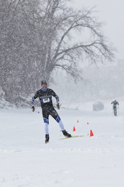 Steve Scoles works his way to the finish line for the win as a burst of heavy snowfall begins during the Olympia St. Marys Winter Triathlon Sunday morning on the Red River Trail. The race consists of a 2KM snowshoe, a 5KM skate and a 5KM ski and around 36 hardy souls took part.  150301 March 01, 2015 Mike Deal / Winnipeg Free Press