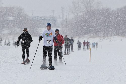 Participants snowshoe through a moderate snowfall during the Olympia St. Marys Winter Triathlon Sunday morning on the Red River Trail. The race consists of a 2KM snowshoe, a 5KM skate and a 5KM ski and around 36 hardy souls took part.  150301 March 01, 2015 Mike Deal / Winnipeg Free Press