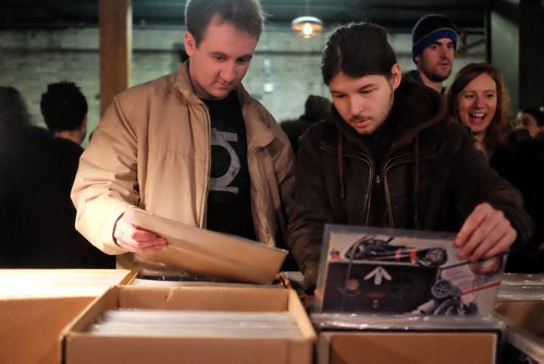 Sean Gault (left) and Patrick Woods (right) were among a steady stream of vinyl lovers browsing through the offerings at the Central City Record Show at Union Sound Hall Sunday afternoon.  150301 March 01, 2015 Mike Deal / Winnipeg Free Press