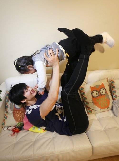 Liang Xing RWB principal male  with his 2 yr old  daughter Vivian Xing in his Winnipeg home See Tait,Bryksa,Zoratti feature - Feb, 2015   (JOE BRYKSA / WINNIPEG FREE PRESS)