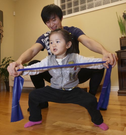 Liang Xing RWB principal male  with his 2 yr old  daughter Vivian Xing in his Winnipeg home See Tait,Bryksa,Zoratti feature - Feb, 2015   (JOE BRYKSA / WINNIPEG FREE PRESS)