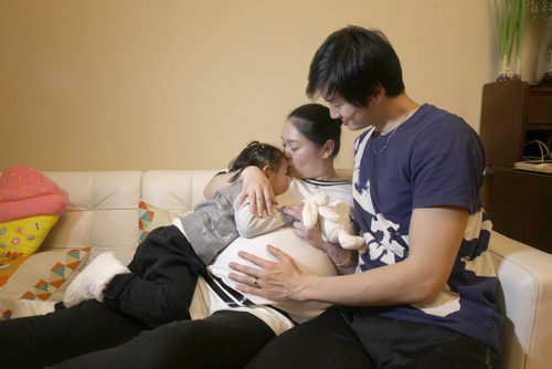 Liang Xing RWB principal male  with his 2 yr old  daughter Vivian Xing and his expecting wife Ke Hu in his Winnipeg home See Tait,Bryksa,Zoratti feature - Feb, 2015   (JOE BRYKSA / WINNIPEG FREE PRESS)