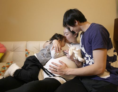 Liang Xing RWB principal male  with his 2 yr old  daughter Vivian Xing and his expecting wife Ke Hu in his Winnipeg home See Tait,Bryksa,Zoratti feature - Feb, 2015   (JOE BRYKSA / WINNIPEG FREE PRESS)